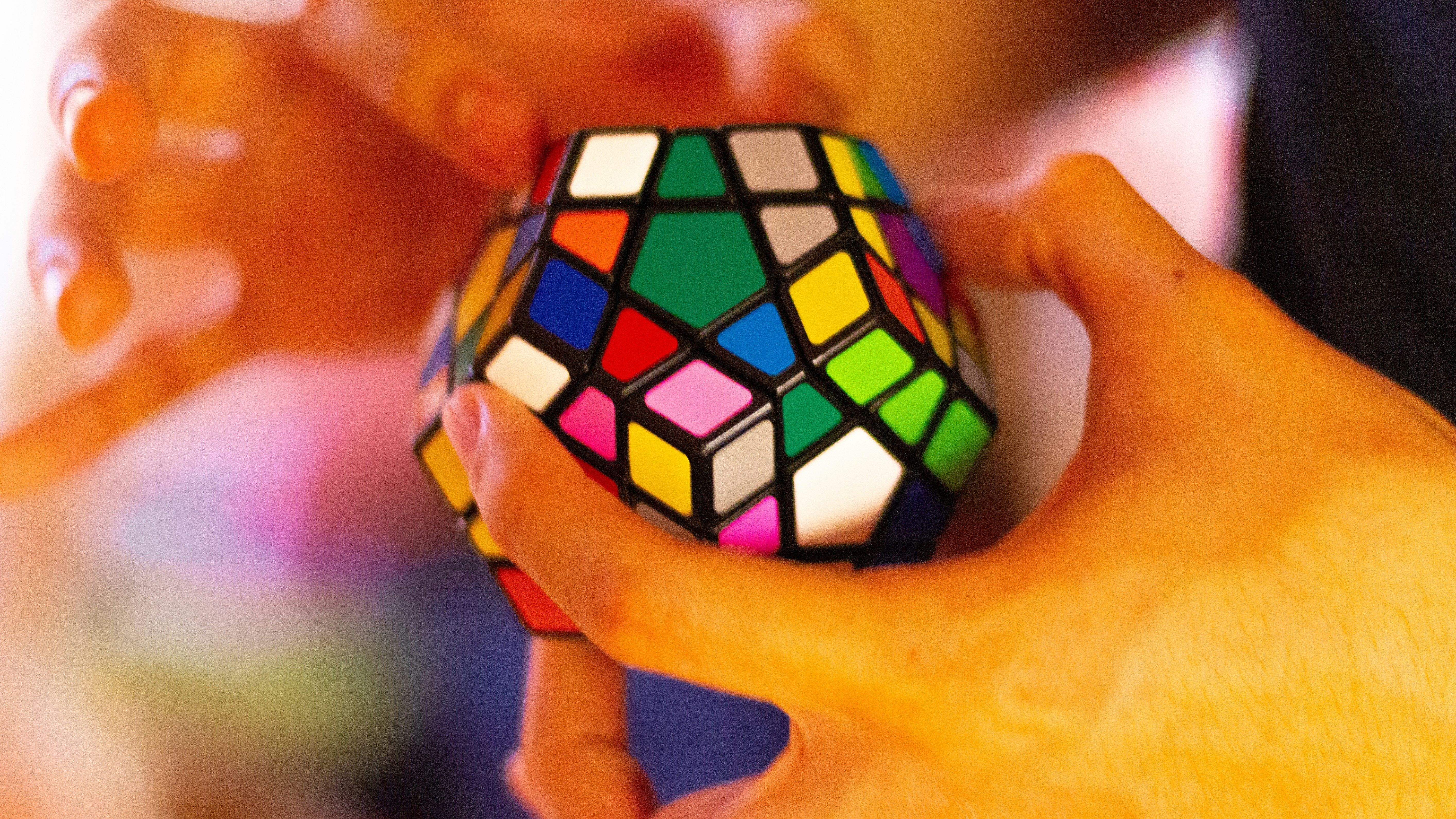 Hands holding a Rubik's cube - puzzle games, pattern practice, and near-transfer cognitive training.
