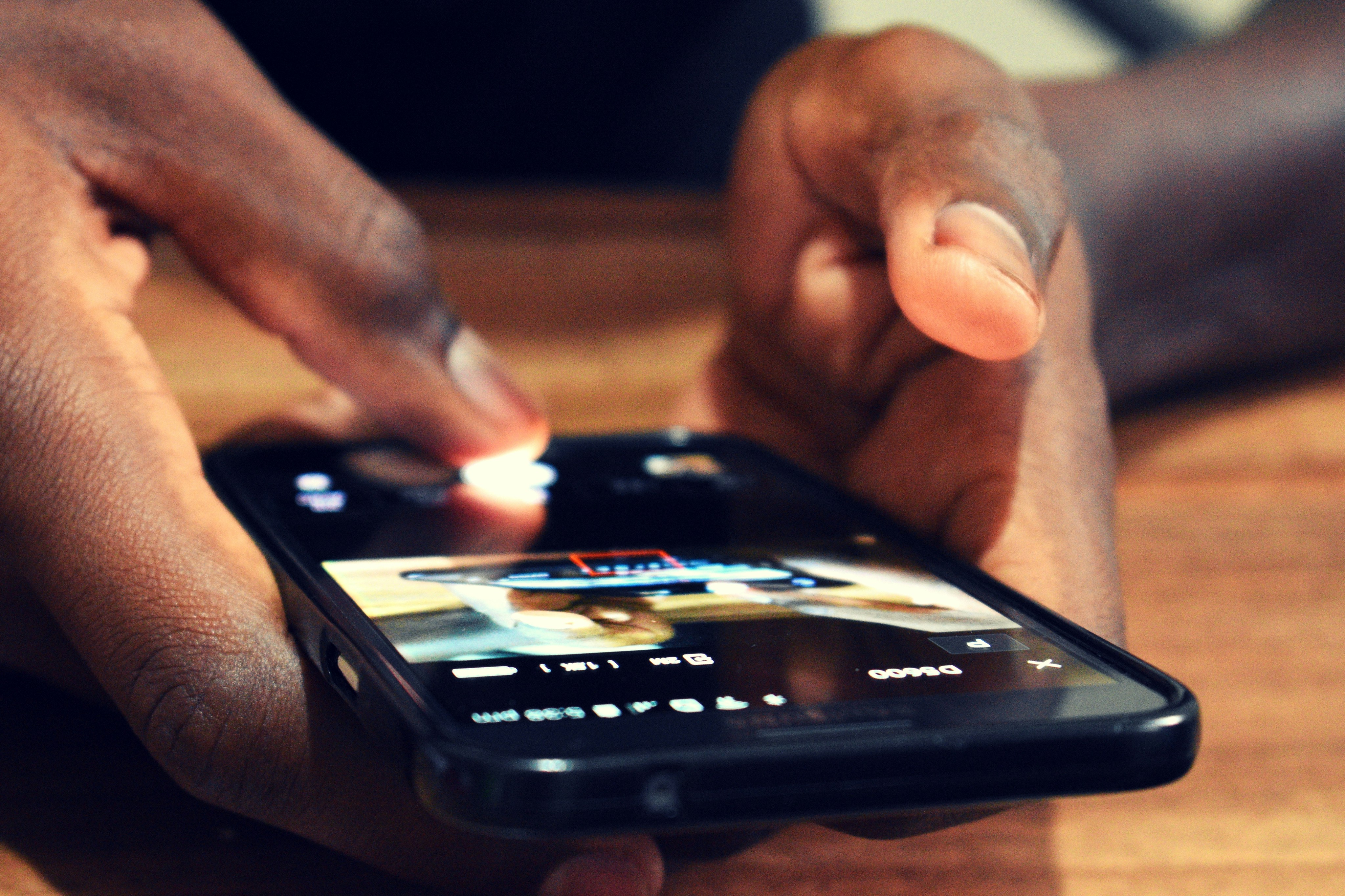 Close-up of a person using a smartphone - apps, attention, and daily cognitive training.
